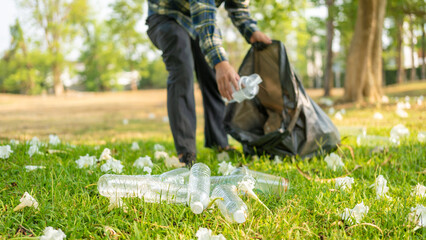 Man collecting plastic bottles, collecting garbage, plastic bottles, taking care of garbage in a national park. Pollution problems. Environmental protection and global warming.