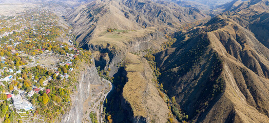 Fototapeta na wymiar Panoramic drone view of Garni village, Azat and Mili rivers gorges on sunny autumn day. Khosrov Reserve, Armenia.