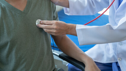 Male doctor is consulting with a young man about prostate cancer and venereal disease and sexual dysfunction about the causes of erectile dysfunction in an examination room.