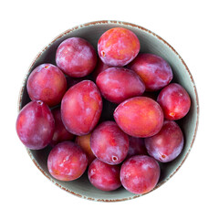 Ripe plums in a bowl isolated on white background. Top view. File contains clipping path.