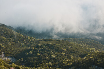 Mountain landscape. Scenic view of mountain peaks, slopes, hills and valleys covered with foggy slopes and valleys. Panoramic view