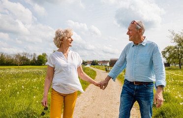Senior husband and wife having a walk in the country during spring