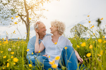 Senior couple in a meadow being happy in love - 602591834