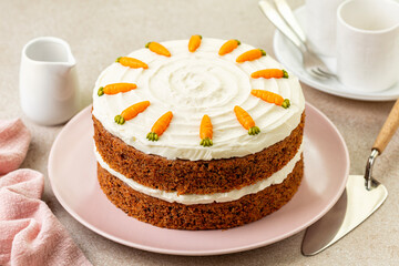 Table with homemade carrot cake made with carrots, walnuts, iced with cream cheese. Chocolate...