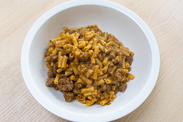 A bowl of macaroni and cheese with beef mince.