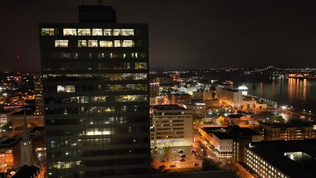 Downtown Baton Rouge, Louisiana at night with drone video moving sideways close up.