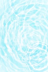 Blue water with ripples on the surface. Defocus blurred transparent blue colored clear calm water surface texture with splashes and bubbles. Water waves with shining pattern texture background.