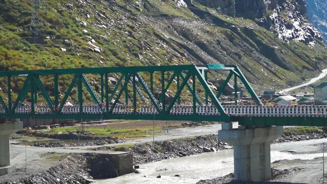Closeup shot of metal bridge above the River Chandra as seen on crossing the Atal Tunnel at Manali in Himachal Pradesh, India. Bridge above the river in Lahaul Valley. Bridge above Himalayan river.