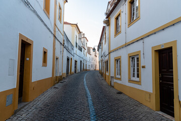 Fototapeta na wymiar Cityscape of Evora with typical houses painted in white and yellow. Alentejo, Portugal
