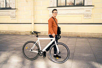 The cyclist is a young guy going to work in formal clothes.