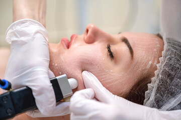 Obraz na płótnie Canvas Closeup of female patient during rejuvenation procedure performed by a professional beautician in a beauty clinic