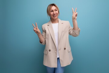 close-up portrait of a positive kind blonde young woman in a stylish elegant look in the studio with copy space