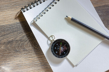 Notebooks with pencil and compass on wooden table