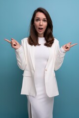 portrait of surprised shocked brunette woman in white dress with nice features