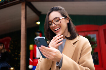 Woman standing on street using mobile phone