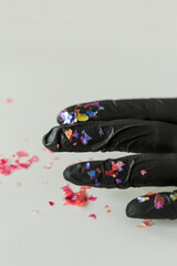 Black gloves covered with glitter for nail art