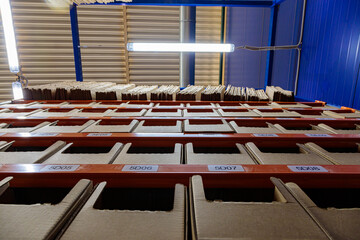 Boxes on racks in a warehouse of goods close-up.