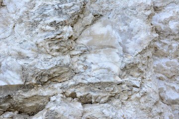 A rock wall with a marble texture isolated, close-up