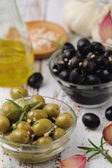 Black and green olives in glass bowls	