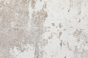 Stucco white aged background. Fragment of a wall in the old town