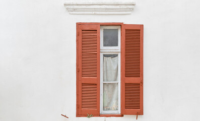 Fototapeta na wymiar Wall of traditional greek house with wooden shutters, idea for background or article, city of Rhodes, travel to popular places of dodecanese archipelago Greece.