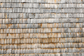 Wooden roof shingles on a wall as creative background