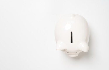 Top view of white piggy bank with copy space for money saving to investment and profit concept.