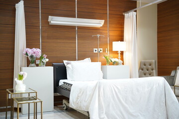 Hospital mother's room after delivering a baby girl. Hospital nice room with pink flowers for mother after giving birth.