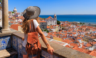 Woman tourist enjoying panoramic view of Lisbon city landscape- Portugal - obrazy, fototapety, plakaty