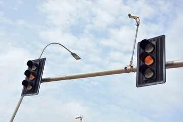 Traffic lights - orange lights and monitoring camera
