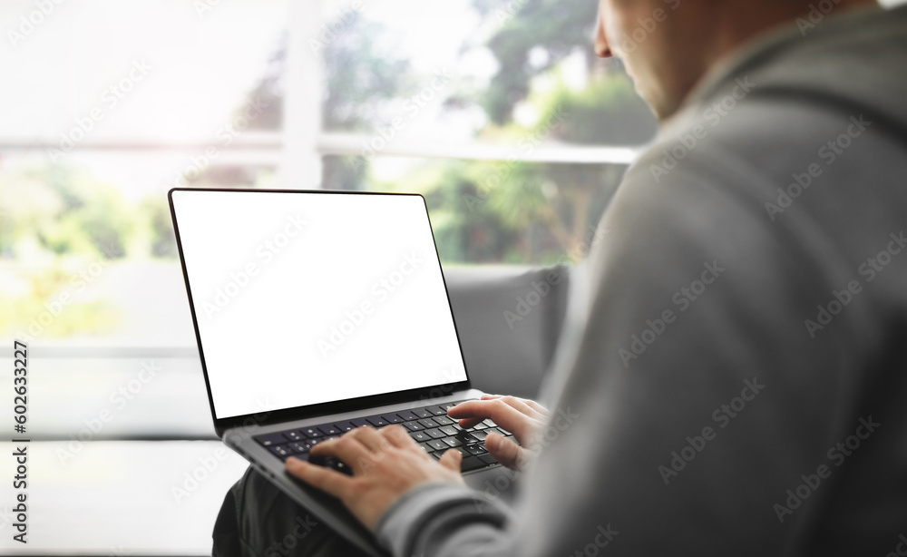 Poster the guy is working on a laptop with a blank screen at home with a view of the park - a template for 