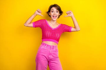 Portrait of good mood ecstatic woman with short haircut wear pink knit top directing at herself...