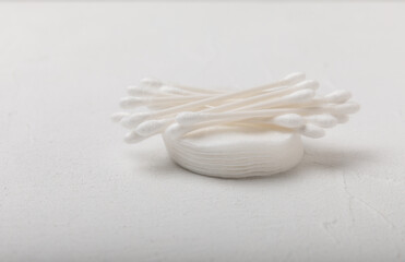 Cotton buds on a textured cement background. Cotton swab on a white background. Sticks for hygiene of the nose and ears. Plastic cotton swabs. Cotton wool. Space for text.Space for copy.