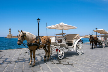 Horse and carriages at the old venetian harbour of Chania, Crete, Greece.