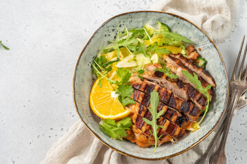 salad with grilled chicken, orange, cucumber and arugula
