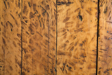 Boards of aged wood of orange color, has dark marks in all its surface.
