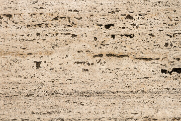 The texture of the stone is notched and mottled. holes notches grooves on the stone.