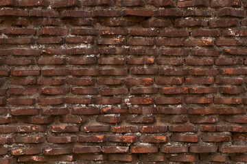 Textured old red brick wall