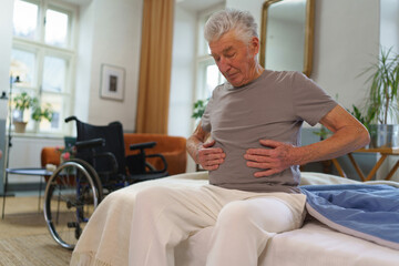 Portrait of senior man with pain in stomach.