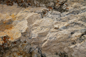 The texture of the stone is notched and mottled. holes notches grooves on the stone.