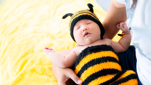 Asian Baby Girl dress in a bee costume,baby in bee costume,newborn baby in bee costume. newborn baby concept shot,