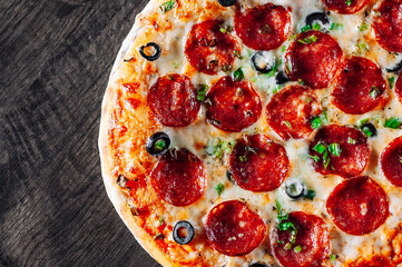 Pepperoni Pizza with Mozzarella cheese, salami, Tomato sauce, pepper, Spices. Italian pizza on wooden table background