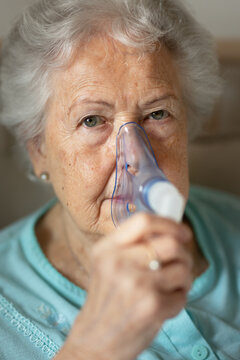 Portrait of senior woman with inhaller, healthcare concept.