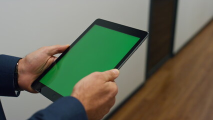 Manager hands holding tablet walking office closeup. Chroma key digital device