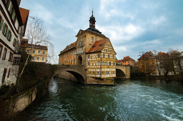 Naklejka na ściany i meble Old town of Bamberg on Romantic road, Upper Franconia, Bavaria, Germany. View of Old Town Hall or Altes Rathaus with two bridges over the Regnitz river.