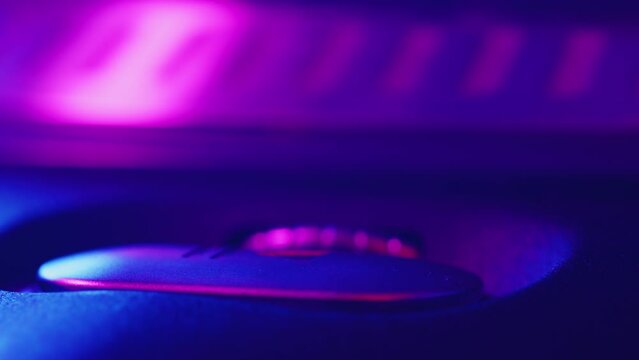 DJ presses the button play on the turntable close up and the record starts to rotate during the studio recording of the vinyl session in a color light