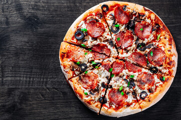Pepperoni Pizza with Mozzarella cheese, salami, Tomato sauce, pepper, Spices. Italian pizza on wooden table background