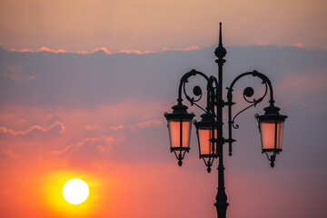 sunset with old lamp at lake garda italy
