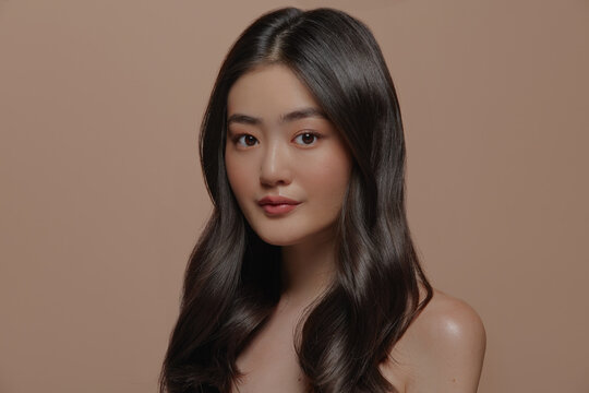 Beautiful young asian woman with clean and smooth fresh skin on beige background. Face care, Facial treatment, Cosmetology, beauty and spa, Asian women portrait.