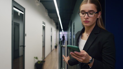 Office manager texting smartphone walking hall closeup. Friendly employee call